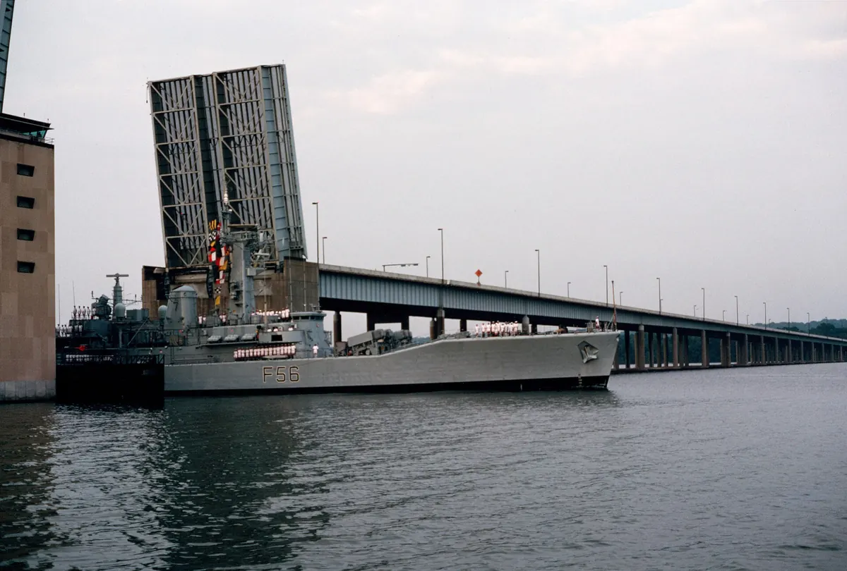 A British frigate passing through the raised draw span of the original Woodrow Wilson Bridge, 1985